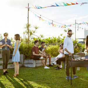 Group of people enjoying a BBQ in the sun