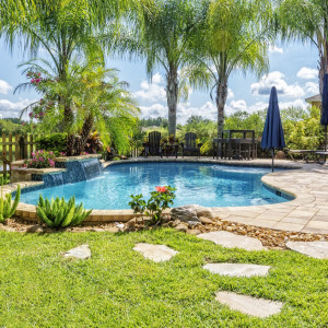 Outdoor swimming pool surrounded by grass